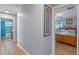 View from hallway into bedroom featuring wooden floors and a large sunny window at 14651 Pine Cone Trl, Clermont, FL 34711