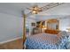 Bedroom featuring a wooden canopy bed, light fixture and dresser at 14651 Pine Cone Trl, Clermont, FL 34711