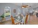 Cozy dining area with large windows, a ceiling fan, and a dining table with seating at 14651 Pine Cone Trl, Clermont, FL 34711