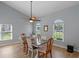 Light-filled dining area with large windows, a ceiling fan, and a dining table with seating at 14651 Pine Cone Trl, Clermont, FL 34711