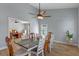 Inviting dining room with a ceiling fan and access to adjacent rooms at 14651 Pine Cone Trl, Clermont, FL 34711