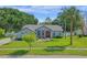 Beautiful one-story home with a green lawn and mature landscaping at 14651 Pine Cone Trl, Clermont, FL 34711