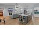 Open-concept living space with a kitchen island and fireplace at 14651 Pine Cone Trl, Clermont, FL 34711