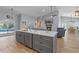 Open-concept living space with a kitchen island and view of pool at 14651 Pine Cone Trl, Clermont, FL 34711