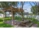 Inviting backyard patio with pergola and outdoor seating, perfect for relaxation at 14651 Pine Cone Trl, Clermont, FL 34711