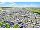 Expansive aerial view of a residential community with well-maintained homes, some featuring pools and solar panels at 15161 Lake Bessie Loop, Winter Garden, FL 34787