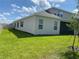 Exterior view of the rear of the home with a large backyard at 15161 Lake Bessie Loop, Winter Garden, FL 34787