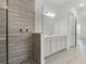This primary bathroom boasts a stylish shower, double vanity and ample lighting at 15161 Lake Bessie Loop, Winter Garden, FL 34787