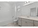 Clean bathroom features a shower-tub combo, a single vanity and a neutral color palette at 15161 Lake Bessie Loop, Winter Garden, FL 34787