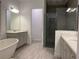 A spacious bathroom features double vanity, freestanding tub and luxurious walk-in shower at 15161 Lake Bessie Loop, Winter Garden, FL 34787