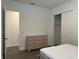 Bedroom with wood-look floors and large dresser at 15161 Lake Bessie Loop, Winter Garden, FL 34787