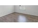 Bedroom features hardwood floors, white walls, and a window providing natural light at 15161 Lake Bessie Loop, Winter Garden, FL 34787