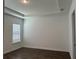 Well-lit bedroom features a window, neutral walls, and wood-look flooring at 15161 Lake Bessie Loop, Winter Garden, FL 34787
