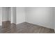 Bedroom features hardwood floors and base molding with neutral paint on the walls at 15161 Lake Bessie Loop, Winter Garden, FL 34787