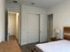 Bedroom with large closet, en-suite bath, and wood-look floors at 15161 Lake Bessie Loop, Winter Garden, FL 34787