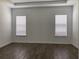 Spacious bedroom with natural light, wood-look floors, and neutral paint at 15161 Lake Bessie Loop, Winter Garden, FL 34787