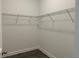 Walk-in closet with wood-look flooring and wire shelving at 15161 Lake Bessie Loop, Winter Garden, FL 34787