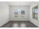 Bright dining room featuring hardwood floors, multiple windows, and a stylish chandelier at 15161 Lake Bessie Loop, Winter Garden, FL 34787