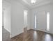Inviting foyer featuring wood-look floors, natural light, and a view of the front door with sidelights at 15161 Lake Bessie Loop, Winter Garden, FL 34787