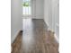 Hallway with wood floors leading to sliding glass doors at 15161 Lake Bessie Loop, Winter Garden, FL 34787