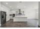 Spacious kitchen featuring an island with stainless steel appliances and white cabinets and countertops at 15161 Lake Bessie Loop, Winter Garden, FL 34787