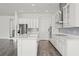 Bright kitchen features white cabinets, stainless steel appliances, and gray subway tile backsplash at 15161 Lake Bessie Loop, Winter Garden, FL 34787