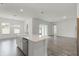 Bright kitchen with an island, stainless steel dishwasher, and a farmhouse sink with modern fixtures at 15161 Lake Bessie Loop, Winter Garden, FL 34787