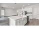 Kitchen with a farmhouse sink, stainless steel dishwasher, and an island with white countertops at 15161 Lake Bessie Loop, Winter Garden, FL 34787