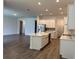 Open concept kitchen features an island, stainless steel appliances, and plenty of cabinet space at 15161 Lake Bessie Loop, Winter Garden, FL 34787