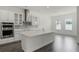 Bright kitchen with an island, stainless steel appliances, and a breakfast nook near a window at 15161 Lake Bessie Loop, Winter Garden, FL 34787