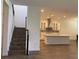 View of the living room featuring stairs and a kitchen with an island and range hood at 15161 Lake Bessie Loop, Winter Garden, FL 34787