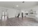 Open-concept living space featuring wood-look floors, recessed lighting, stairs, and a modern kitchen at 15161 Lake Bessie Loop, Winter Garden, FL 34787