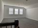 Spacious upstairs loft area with soft carpeting and three bright windows at 15161 Lake Bessie Loop, Winter Garden, FL 34787