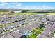 Aerial view showing a well-developed suburban area with homes, pools, and green spaces at 15161 Lake Bessie Loop, Winter Garden, FL 34787