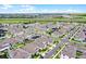 Scenic aerial view of a suburban neighborhood with modern houses, well-kept landscaping, and curving streets at 15161 Lake Bessie Loop, Winter Garden, FL 34787