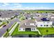 Aerial view capturing the rear of a modern home with well-kept lawn, pool, and a glimpse of the vibrant neighborhood at 15161 Lake Bessie Loop, Winter Garden, FL 34787