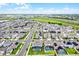 Panoramic aerial view of a residential neighborhood featuring modern homes, lush greenery, and recreational amenities at 15161 Lake Bessie Loop, Winter Garden, FL 34787
