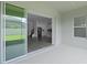 View of the patio with sliding glass doors leading to the kitchen and staircase at 15161 Lake Bessie Loop, Winter Garden, FL 34787