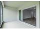 View of the patio with sliding glass doors leading into a spacious living area with hardwood flooring at 15161 Lake Bessie Loop, Winter Garden, FL 34787