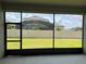 View of backyard and neighboring house from the screened patio at 15161 Lake Bessie Loop, Winter Garden, FL 34787