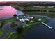 Aerial view of clubhouse and lake at sunset at 15698 Panther Lake Dr, Winter Garden, FL 34787