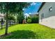 Well-manicured backyard with lush green lawn and play structure, surrounded by trees and privacy fence at 15698 Panther Lake Dr, Winter Garden, FL 34787