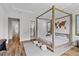 This bedroom has a unique, modern four-poster bed and light wood floors at 15698 Panther Lake Dr, Winter Garden, FL 34787