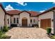 Luxurious home featuring a brick driveway leading up to a striking double door entrance at 15698 Panther Lake Dr, Winter Garden, FL 34787