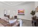 Cozy living area featuring comfortable seating, a large TV, and elegant decor at 15698 Panther Lake Dr, Winter Garden, FL 34787