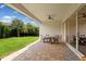 Spacious covered patio with outdoor dining area and lush green backyard at 15698 Panther Lake Dr, Winter Garden, FL 34787