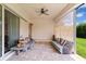 Relaxing covered patio with comfortable seating and view of the backyard at 15698 Panther Lake Dr, Winter Garden, FL 34787
