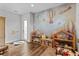 Bright playroom features hot air balloon wallpaper and plenty of space for fun at 15698 Panther Lake Dr, Winter Garden, FL 34787