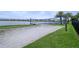 Community sand volleyball court situated near a pond and lush green lawns at 15698 Panther Lake Dr, Winter Garden, FL 34787