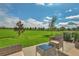 Outdoor patio with furniture and lush green field views, perfect for relaxing and entertaining guests at 1615 Sanibel Dr, Davenport, FL 33896